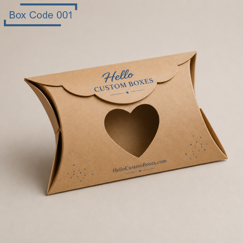Brown kraft pillow gift boxes with heart-shaped cut-out window on the front, scalloped flap closure, branded with “Hello Custom Boxes”, decorative small dots detail.